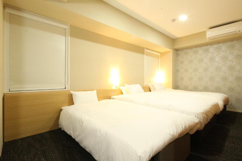 Postel nebo postele na pokoji v ubytování AB Hotel Hikone