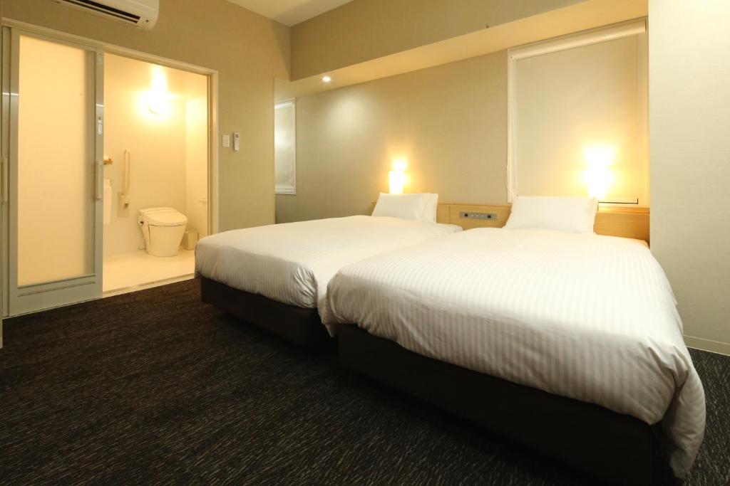 Postel nebo postele na pokoji v ubytování AB Hotel Hikone