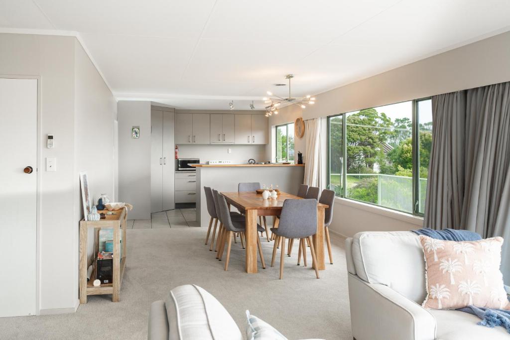 a kitchen and living room with a table and chairs at Russell HQ in Russell