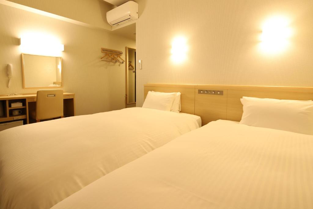 Postel nebo postele na pokoji v ubytování AB Hotel Gamagori