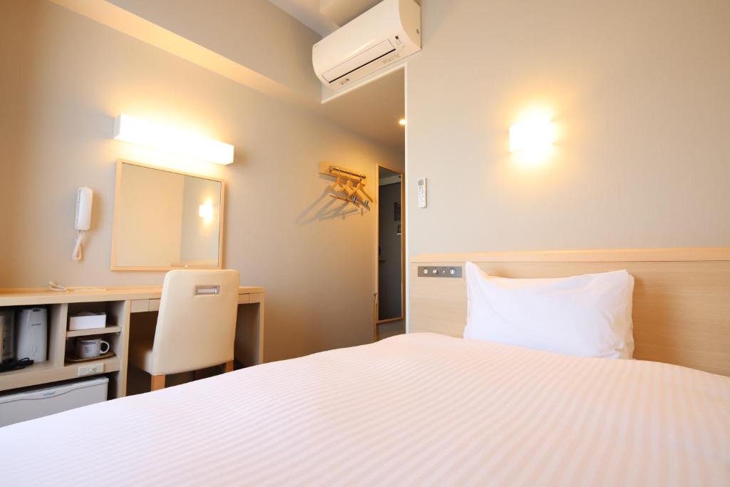 Postel nebo postele na pokoji v ubytování AB Hotel Gamagori