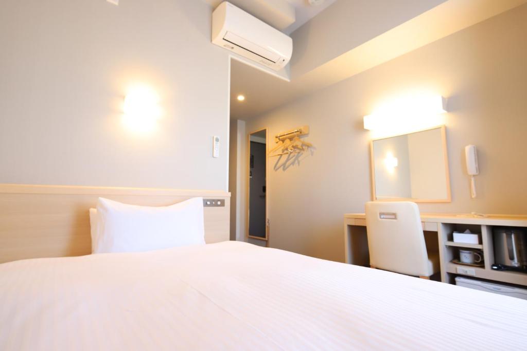 Postel nebo postele na pokoji v ubytování AB Hotel Gamagori