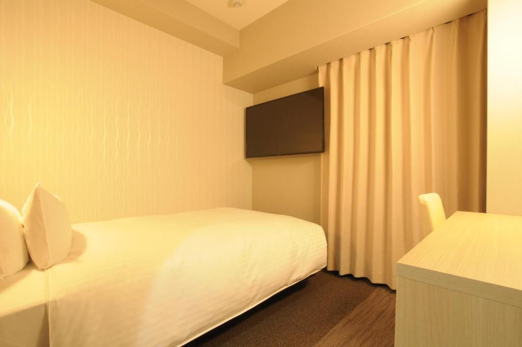 Letto o letti in una camera di AB Hotel Tahara