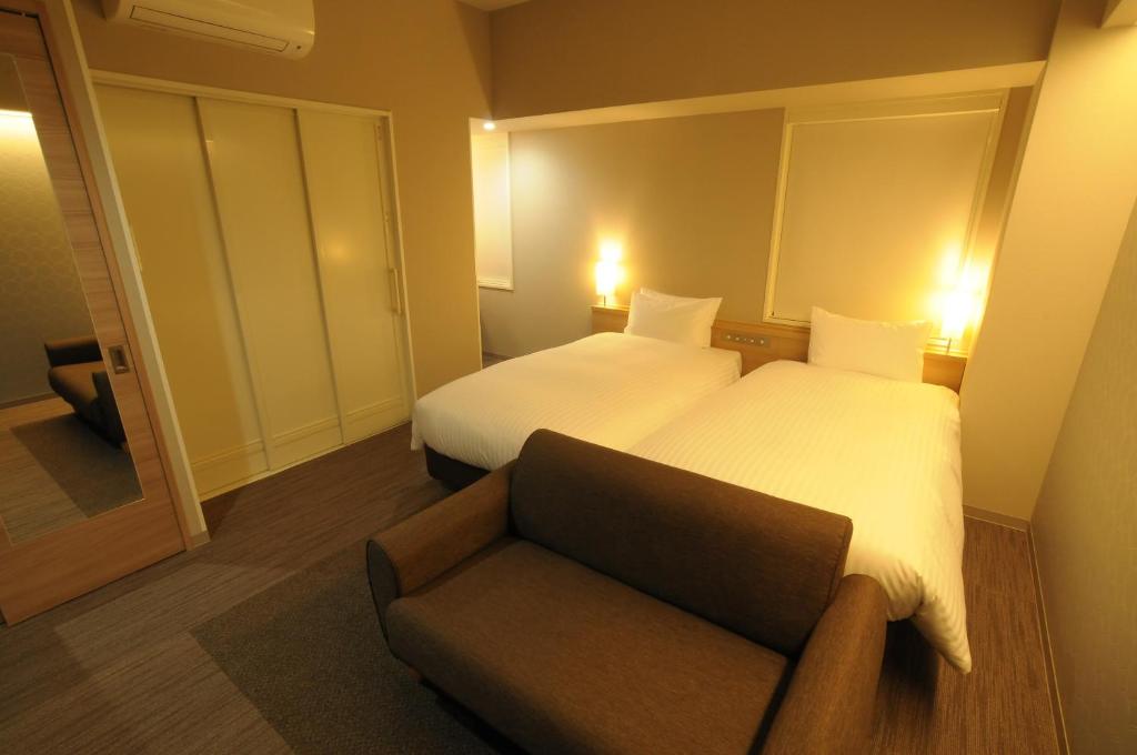 Letto o letti in una camera di AB Hotel Tahara