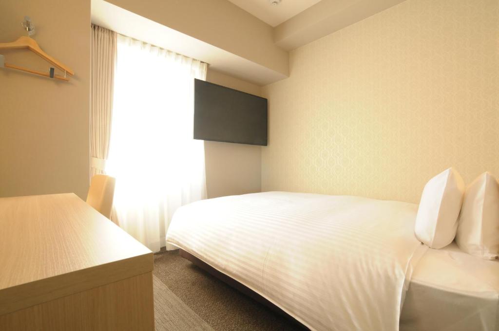 Letto o letti in una camera di AB Hotel Tahara