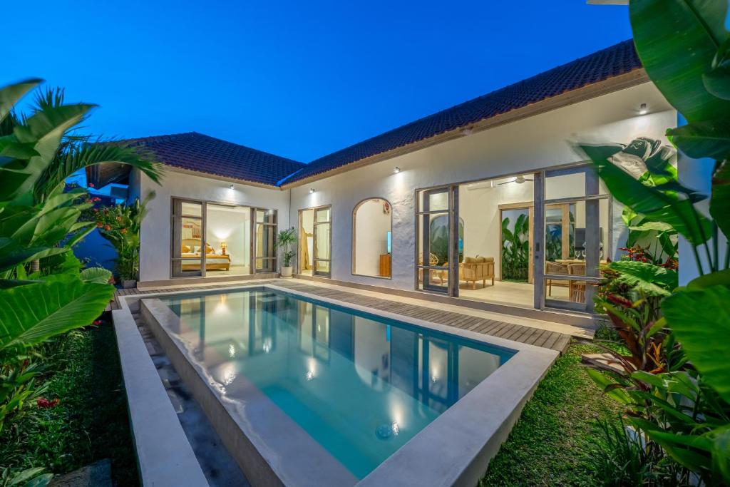 an exterior view of a villa with a swimming pool at Bambola - Stunning New Luxury Villa in Kerobokan with Expansive Pool - Your Dream Home Awaits! in Canggu