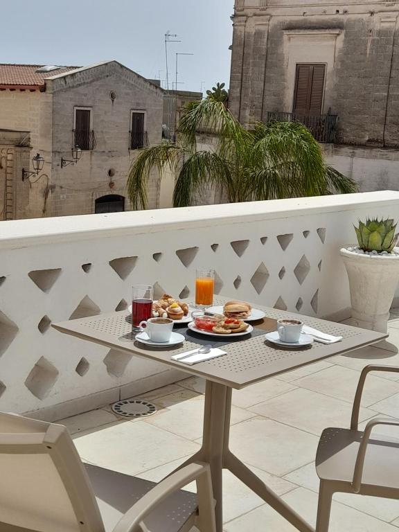 a tray of food on a table on a balcony at Dallatorre B&B in Lizzano