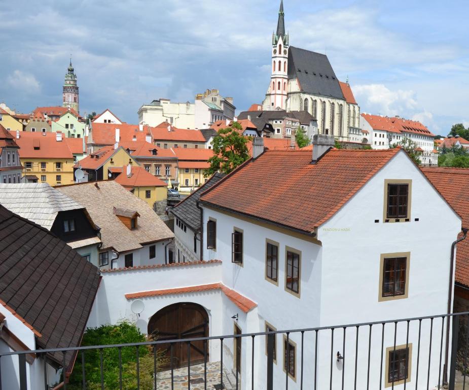 a view of a city with buildings and a church at Pension U Hada in Český Krumlov
