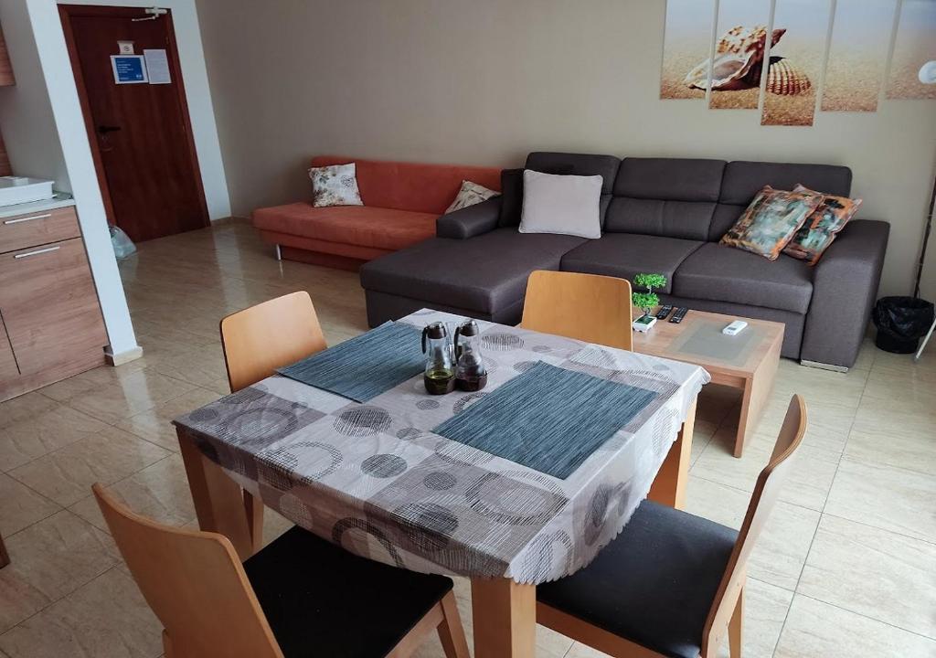 a living room with a table and a couch at Charis Cozy Family apart at Sun Village Complex close to the Beach in Sunny Beach