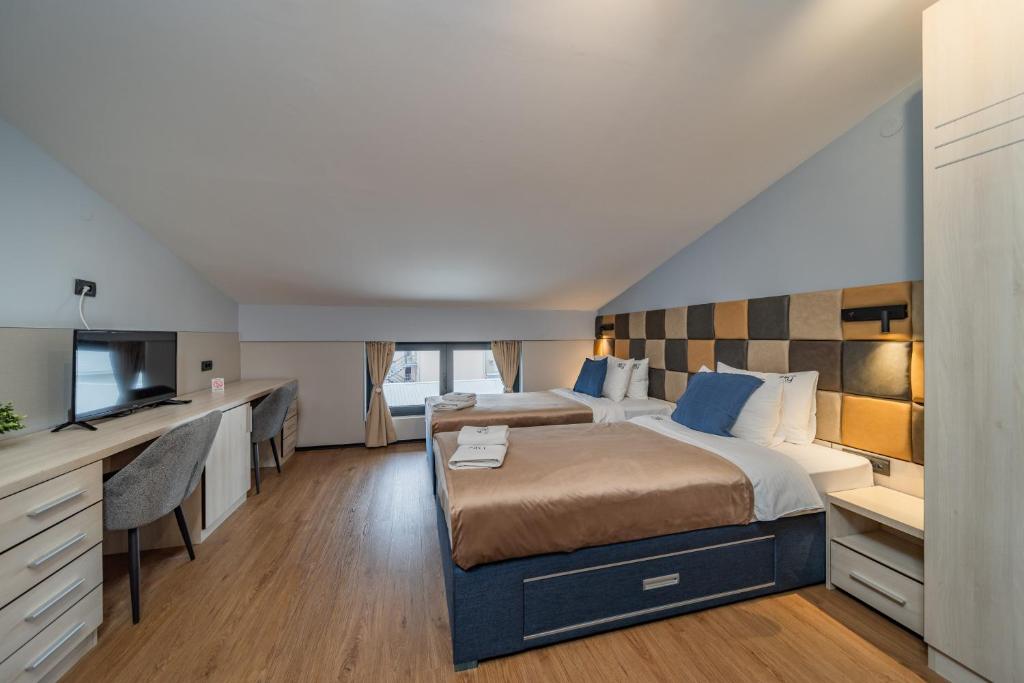 Postel nebo postele na pokoji v ubytování Hotel Garni VIZURA Sport