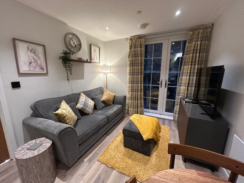 ein Wohnzimmer mit Sofa und Fernseher in der Unterkunft Rock Mill - Luxury 1 Bedroom Apartment 20 in Stony Middleton