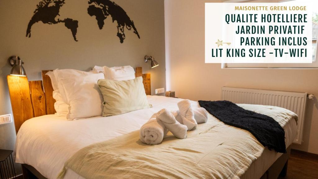 a bed with a teddy bear on top of it at Gite See You Soon - Maisonnette Green Lodge in Ribeauvillé
