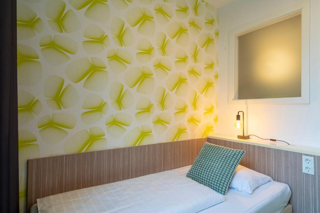 Postel nebo postele na pokoji v ubytování Hotel Madeleine Biohotel