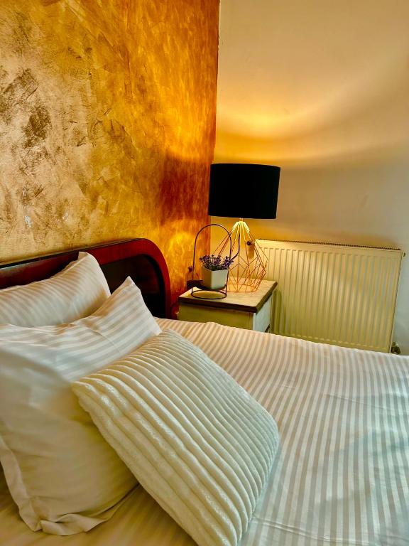 a bedroom with a bed and a table with a television at Iulius Mall Area Apartament in Iaşi