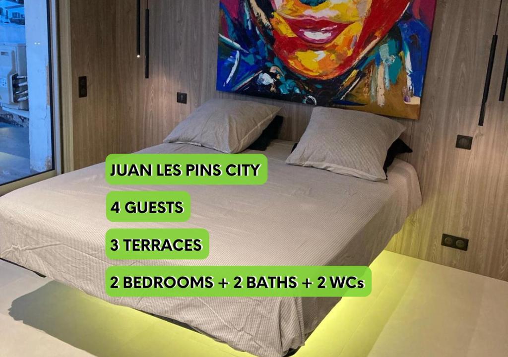 une photo d'un lit avec une peinture murale dans l'établissement TOP 3 pièces Juan Les Pins, à Antibes