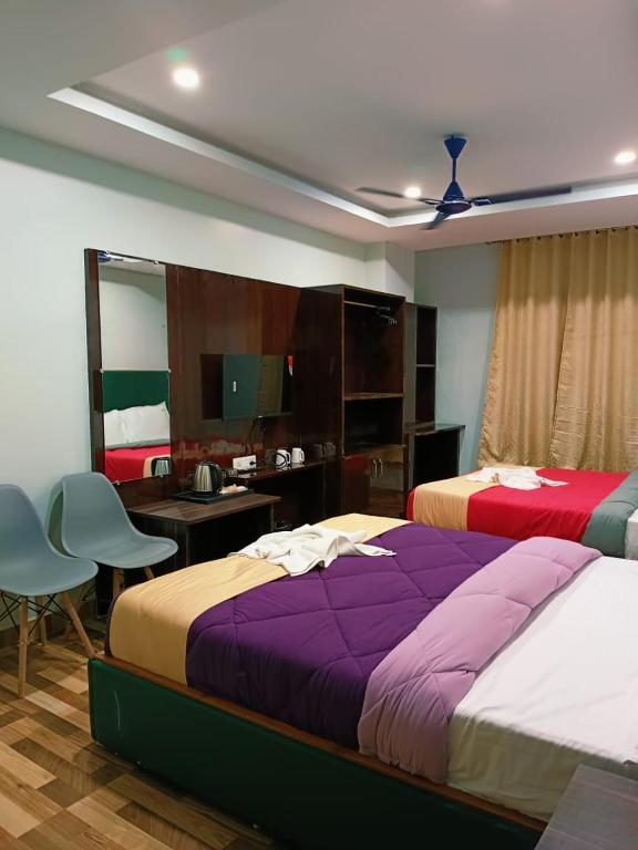 Postel nebo postele na pokoji v ubytování Hotel HK Regency