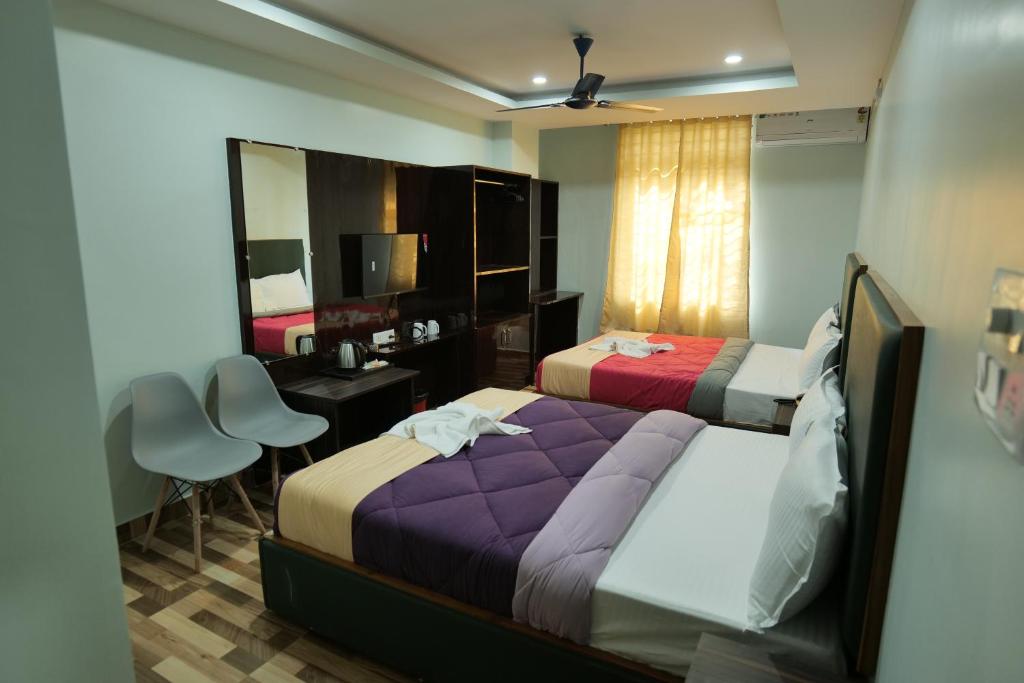 Postel nebo postele na pokoji v ubytování Hotel HK Regency