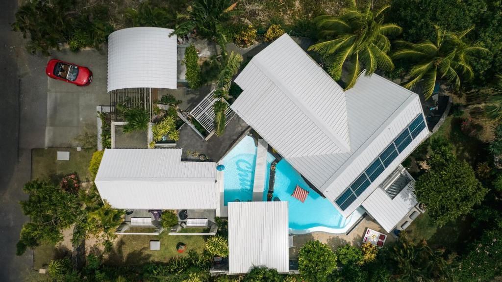 an overhead view of a large white building with a swimming pool at The Number 41 in Rivière Noire