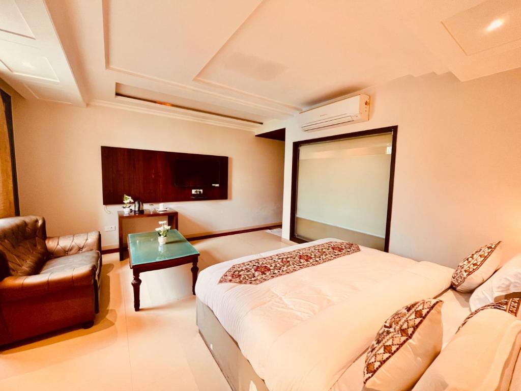 Postel nebo postele na pokoji v ubytování Hotel Bhoomivilas