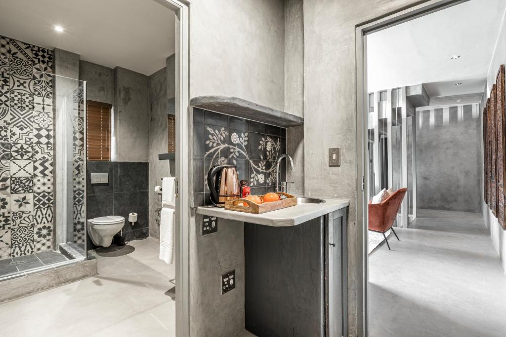 a bathroom with a sink and a toilet at Belle Maroc Boutique Hotel in Bloubergstrand