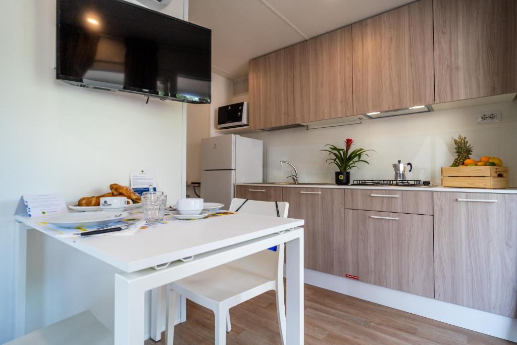 a kitchen with a white island in a room at Club del Sole Viareggio Family Collection in Torre del Lago Puccini