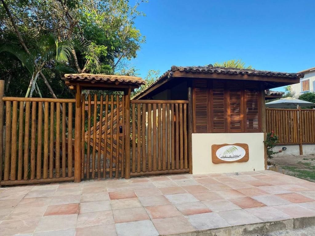 a wooden fence with a gate and a shelter at Chalés de Imbassaí - Chalé 4 in Mata de Sao Joao