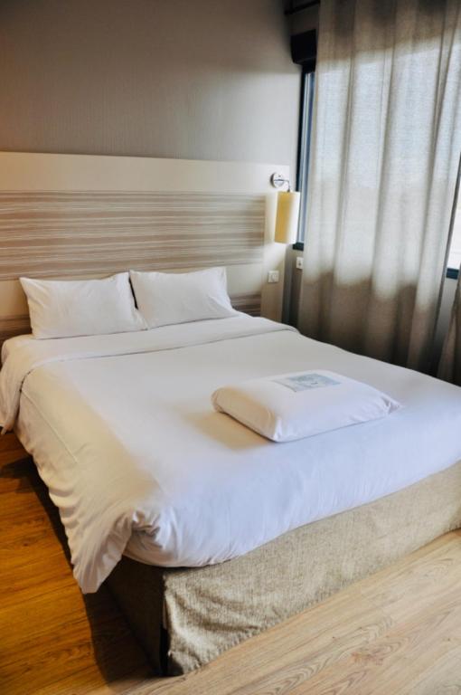 Letto o letti in una camera di Kyriad Toulouse Sud - Roques