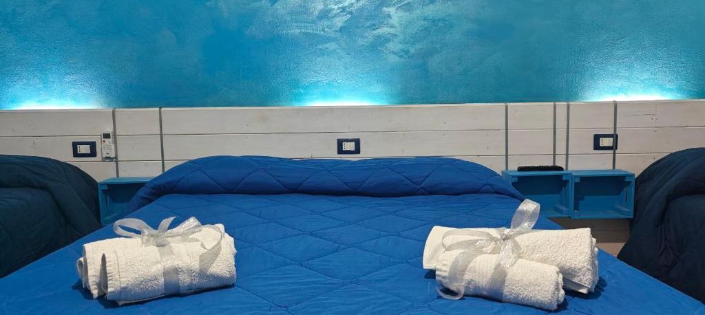 Postel nebo postele na pokoji v ubytování Nettuno Rooms