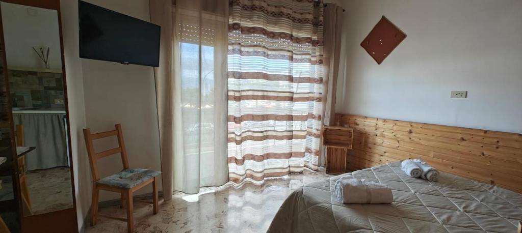 Postel nebo postele na pokoji v ubytování Nettuno Rooms
