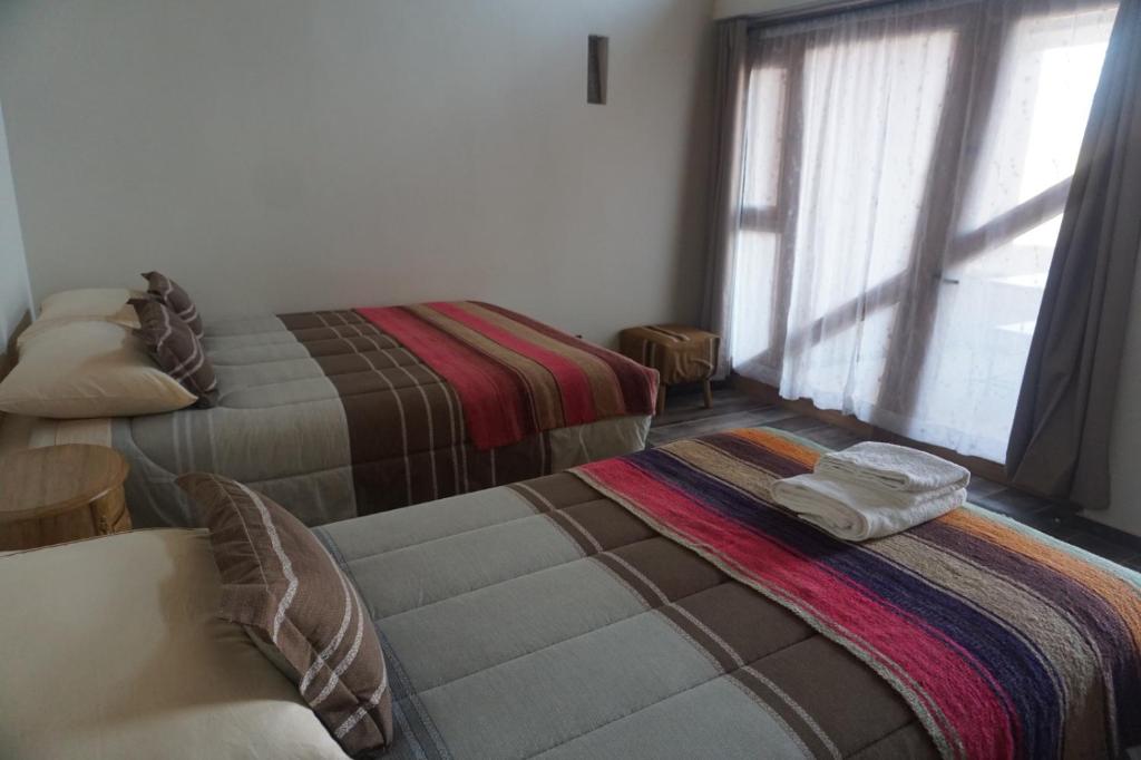 Postel nebo postele na pokoji v ubytování Hotel Pirwa