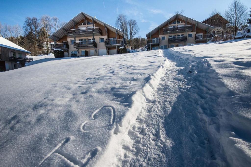 a house in the snow with a heart drawn in it at Les Adrets in Gérardmer