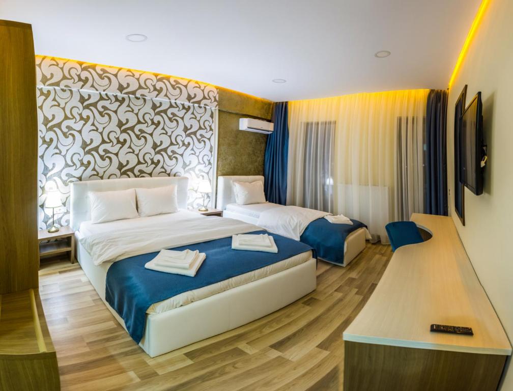 Postel nebo postele na pokoji v ubytování Monopoly Hotel