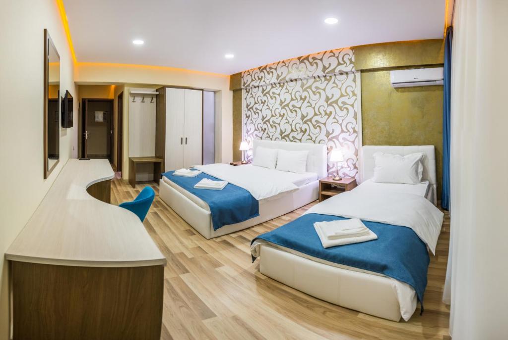 Postel nebo postele na pokoji v ubytování Monopoly Hotel