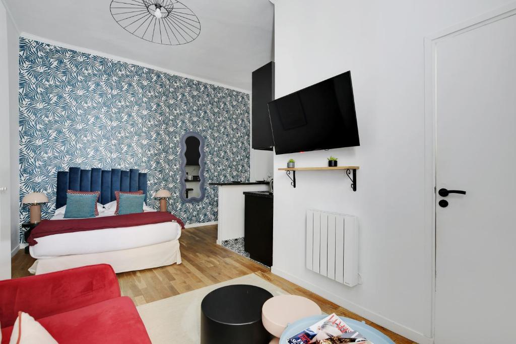 - un salon avec un canapé rouge et un fauteuil rouge dans l'établissement CMG Résidence Bastille - Saint Antoine, à Paris