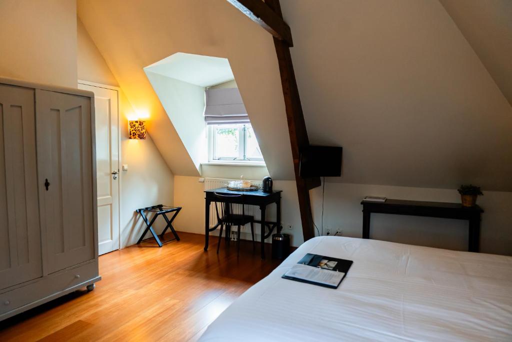 Postel nebo postele na pokoji v ubytování B&B Het Wellnest