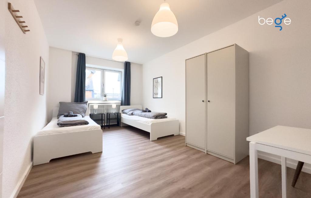 a living room with two beds and a cabinet at BEGE APARTMENTS ConnectPoint in Nettetal