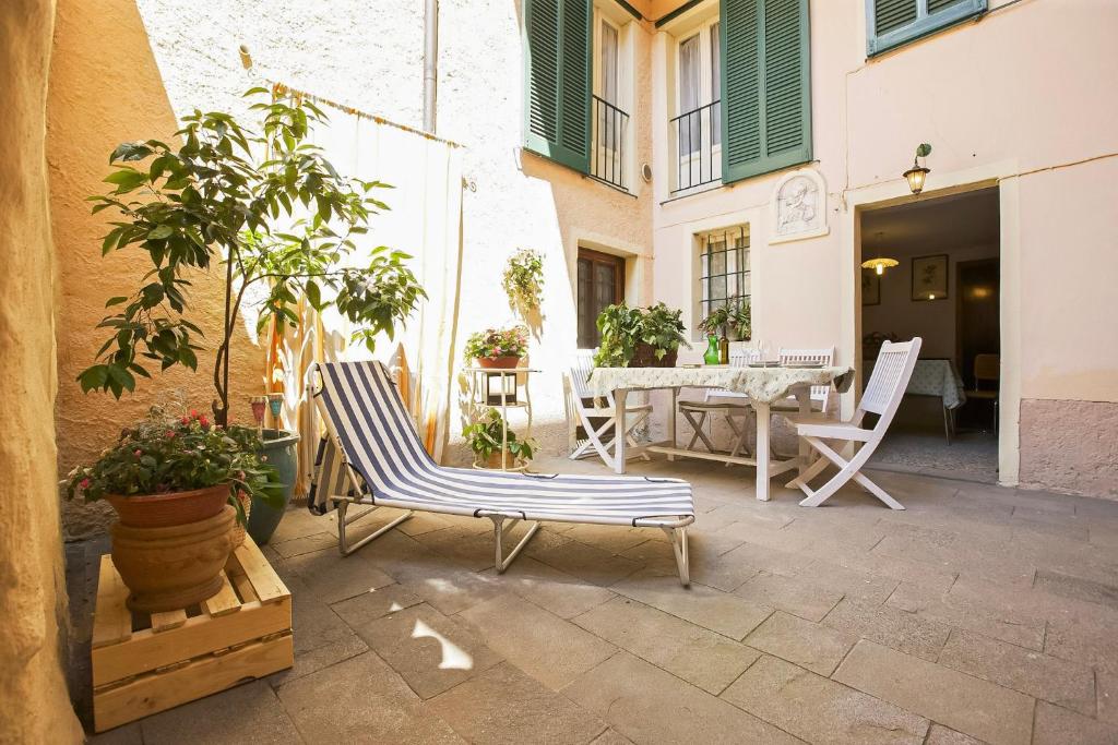 a patio with two chairs and a table and a table at Casa Maria Vittoria in Cannero Riviera