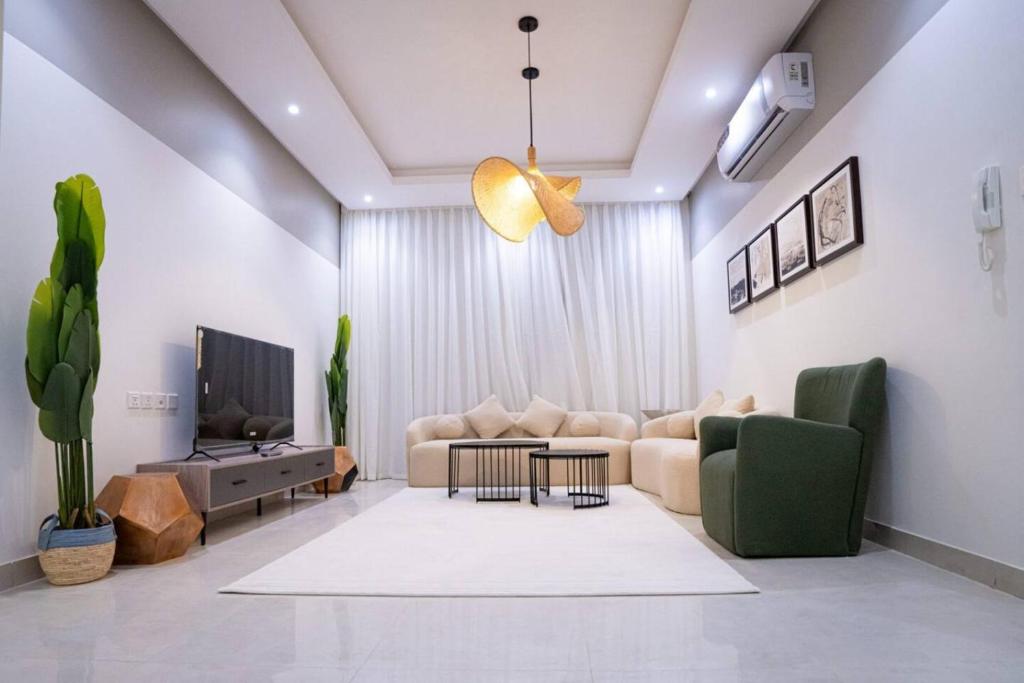 a living room with a couch and a table at 005 - Saudi - Elegant apartment in Riyadh (Noor) in Al Hofuf
