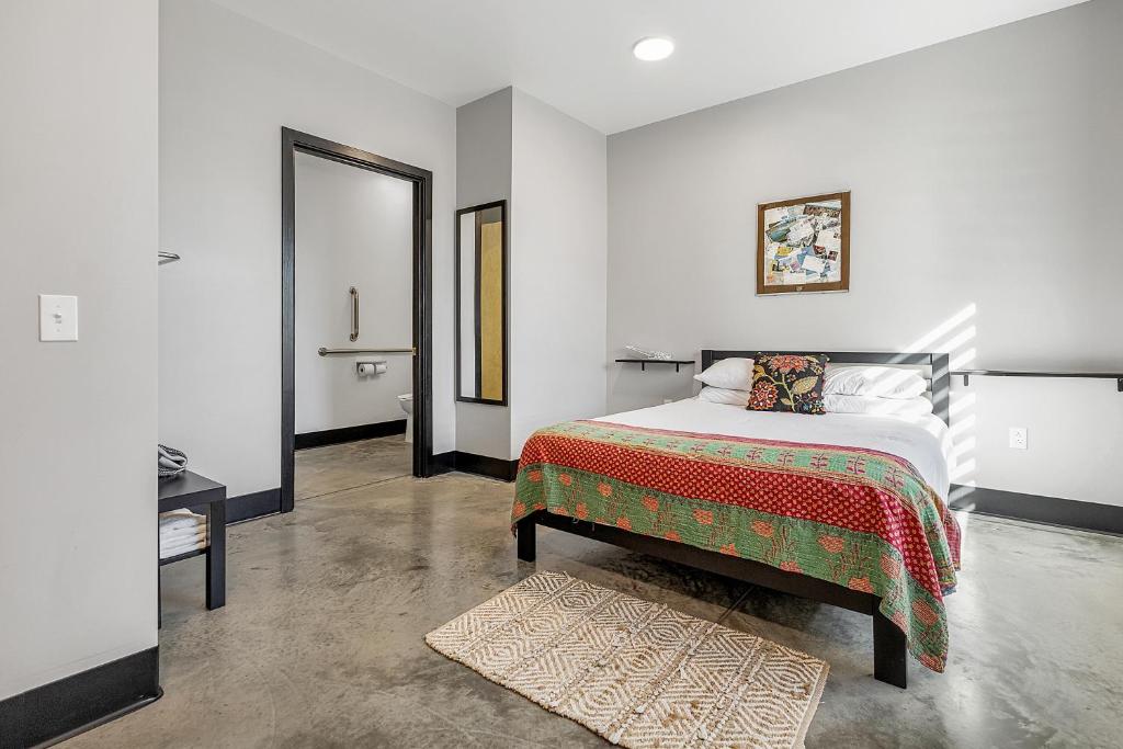 a bedroom with a large bed and a mirror at First Floor Room With Chef's Kitchen And Pool in Pacific