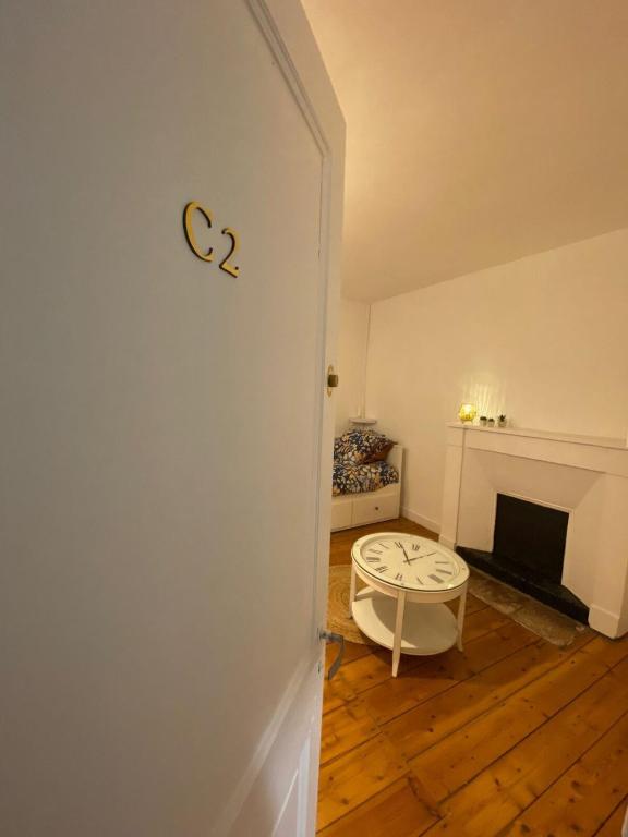 Cette chambre dispose d'une cheminée et d'une porte avec un tabouret. dans l'établissement L'Imprimerie C2, studio cosy au coeur La Roche, à La Roche-sur-Yon