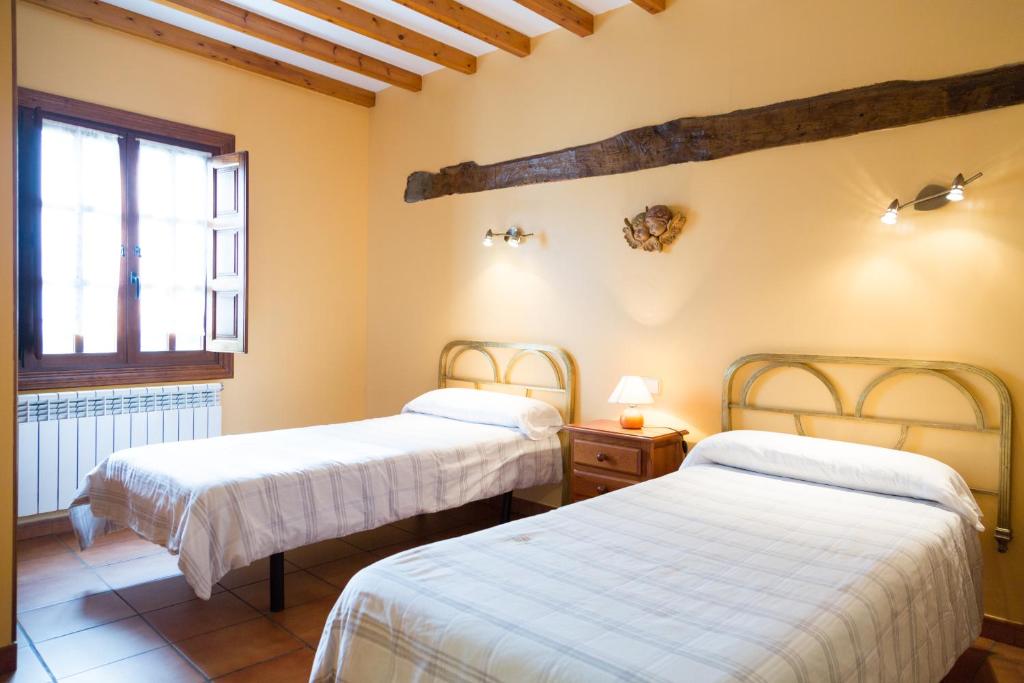 Postel nebo postele na pokoji v ubytování Viviendas rurales Fuente Domingo