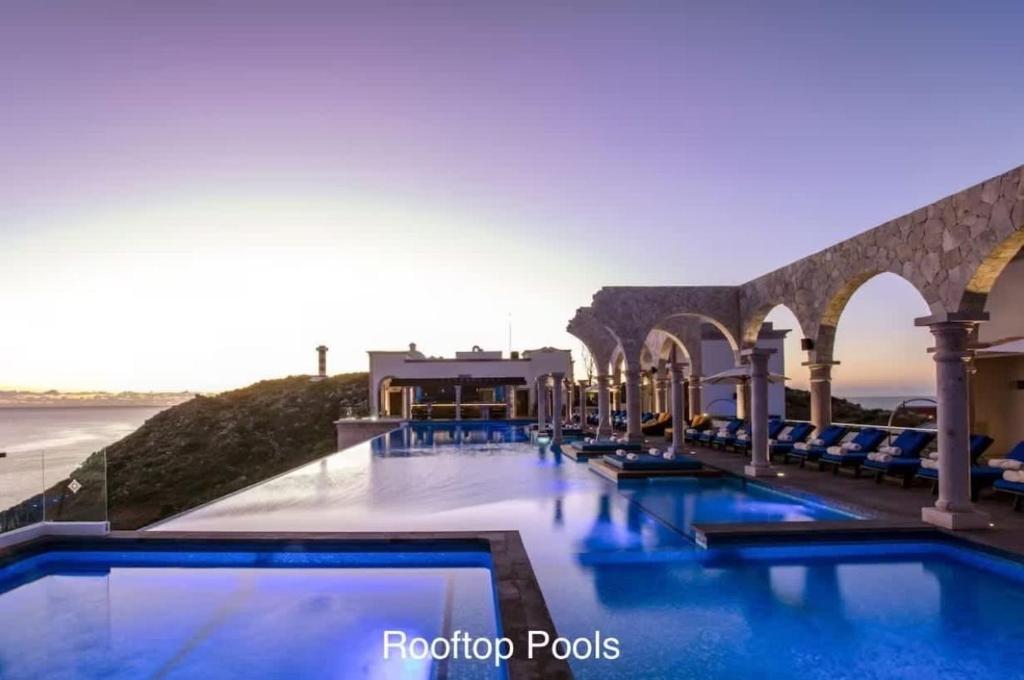 a pool at a hotel with a view of the ocean at 4BD Oceanfront Unit Vista Encantada - Cabo in Cabo San Lucas