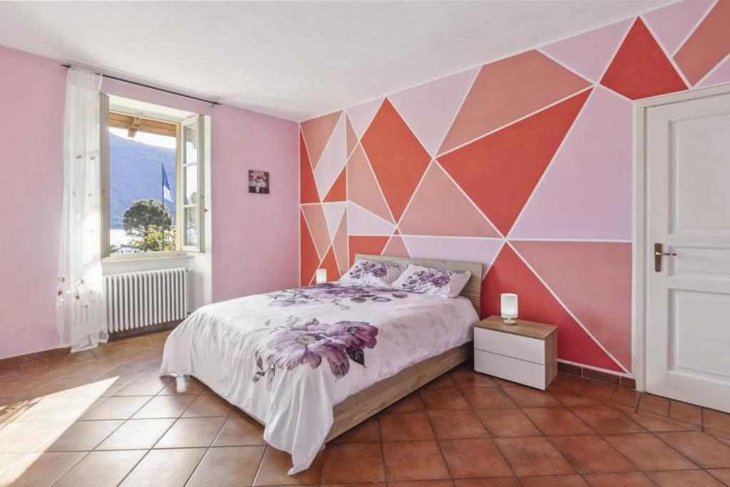 a bedroom with a bed and a geometric wall at La Veduta in Cannobio