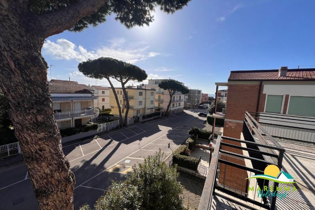 a view of a street with trees and buildings at Pratoranieri - Sparviero in Follonica