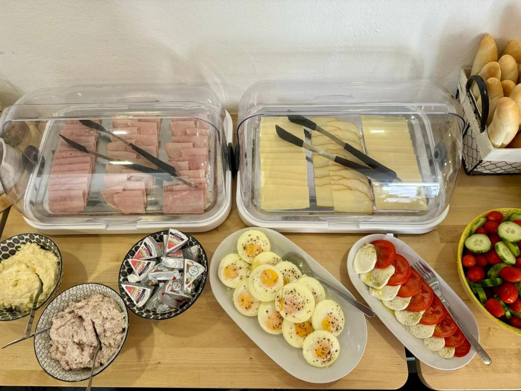 a table topped with trays of food and plates of food at Hotel Vincent in Luhačovice