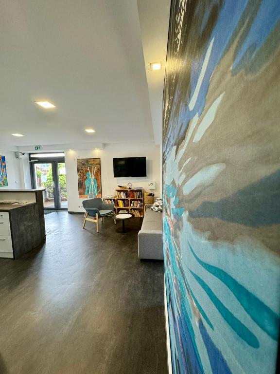 a living room with a large painting on the wall at Hotel Vincent in Luhačovice