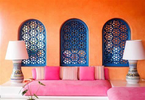 a living room with a pink couch and two lamps at Atmosphérique Paradise in Tamraght Ouzdar
