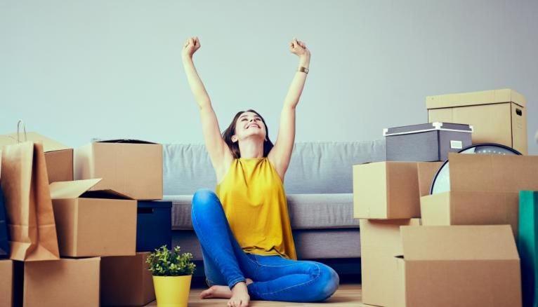 a woman sitting on the floor in front of a pile of boxes at test etablissement in Sfax
