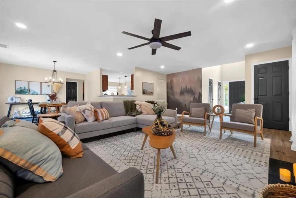 a living room with a couch and a ceiling fan at Family Home w FirePit GameRm Patio BbqGrill in Lilburn
