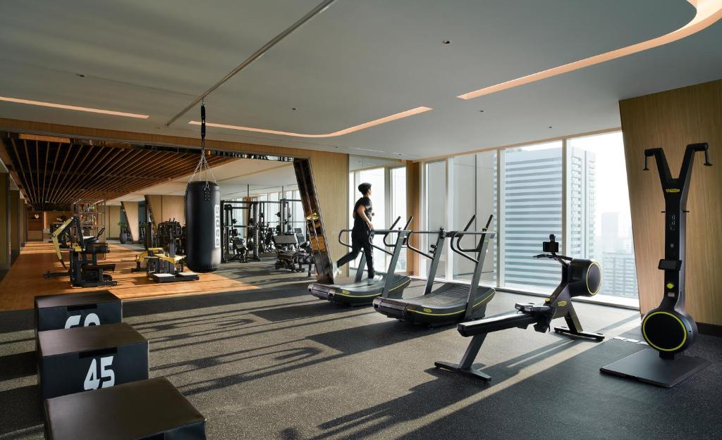 A bright, panoramic fitness room overlooks the city.